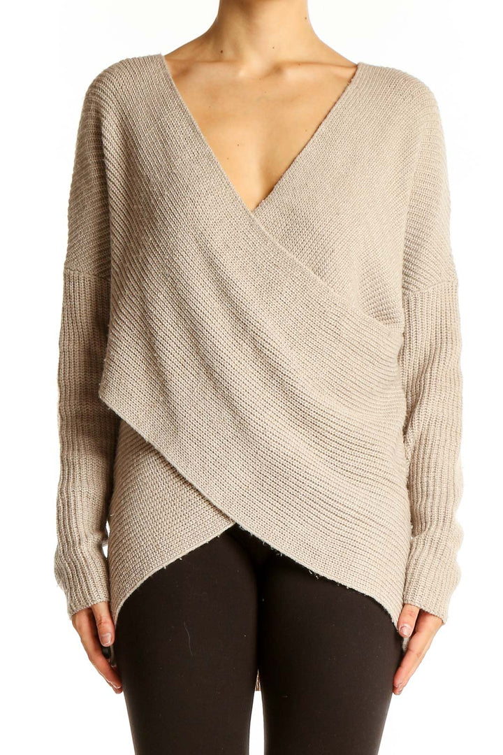 Front view of beige ASTR wrap-style oversized knit sweater with V-neckline