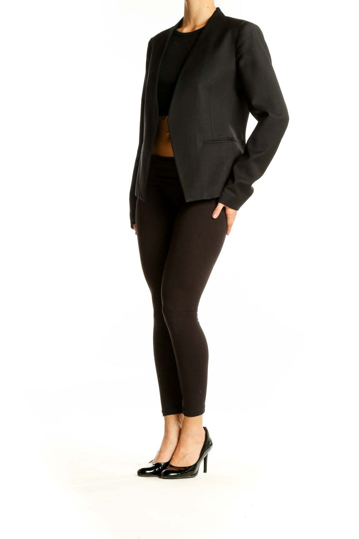 Front view of black Theory open-front blazer on model