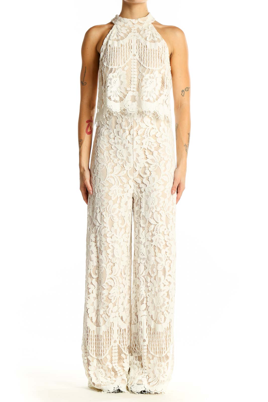 Front view of Lulu's ivory lace halter neck jumpsuit with fringe details