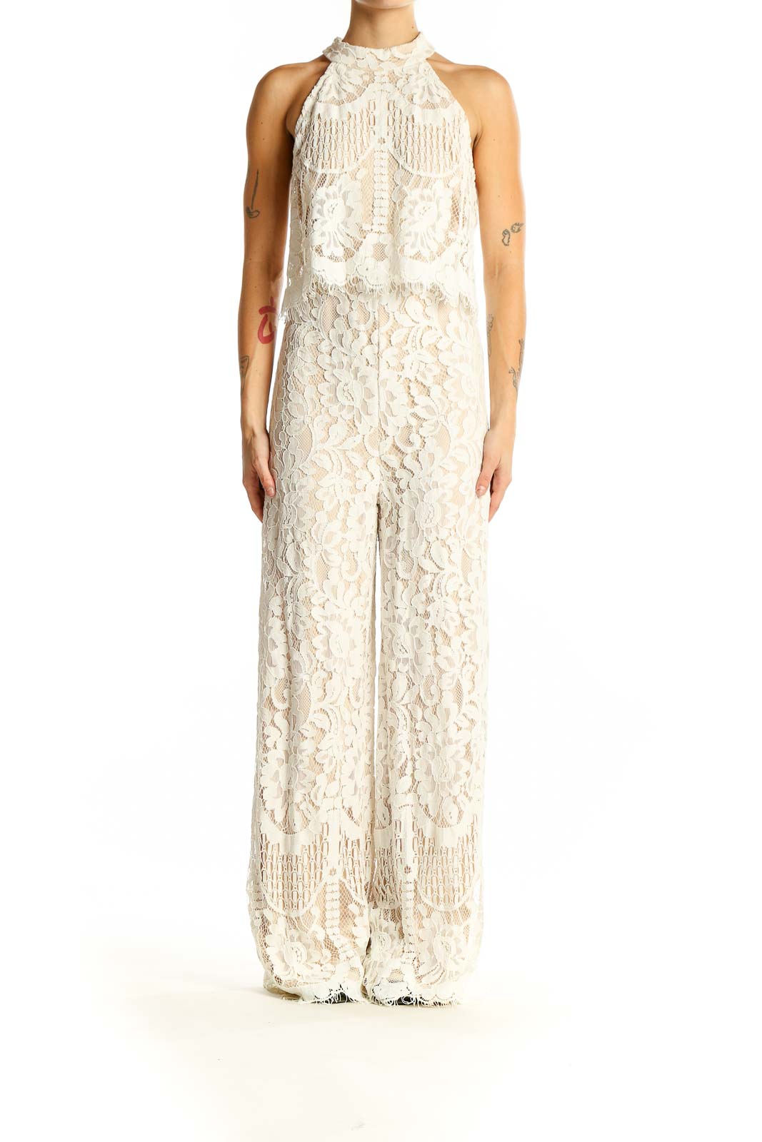 Front view of Lulu's ivory lace halter neck jumpsuit with fringe details