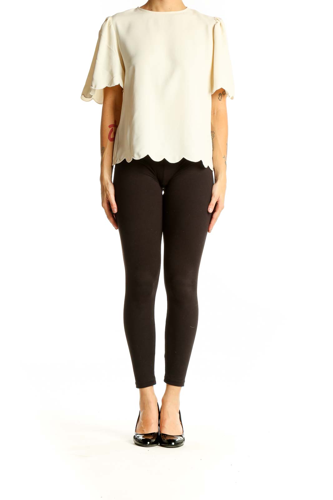 Front view of Express cream blouse with scalloped hem and short sleeves