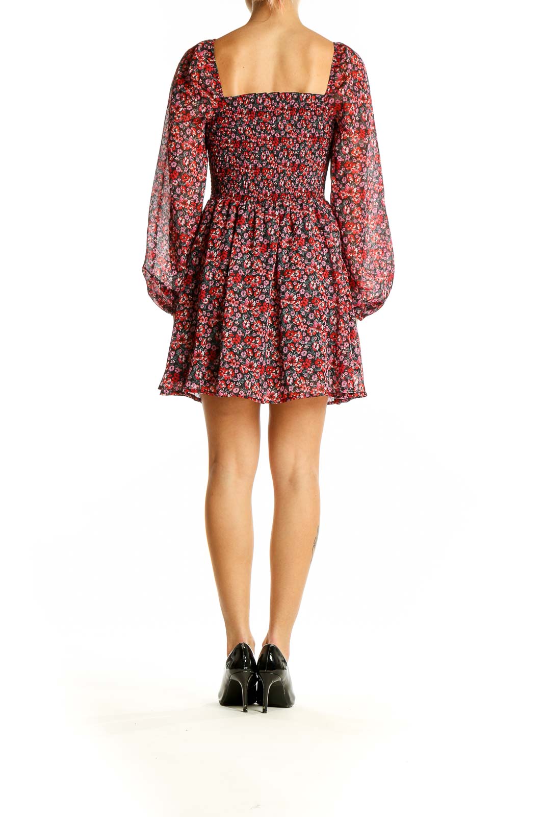 Side view of Francesca's red floral smocked mini dress showing flared skirt and billowing sleeves