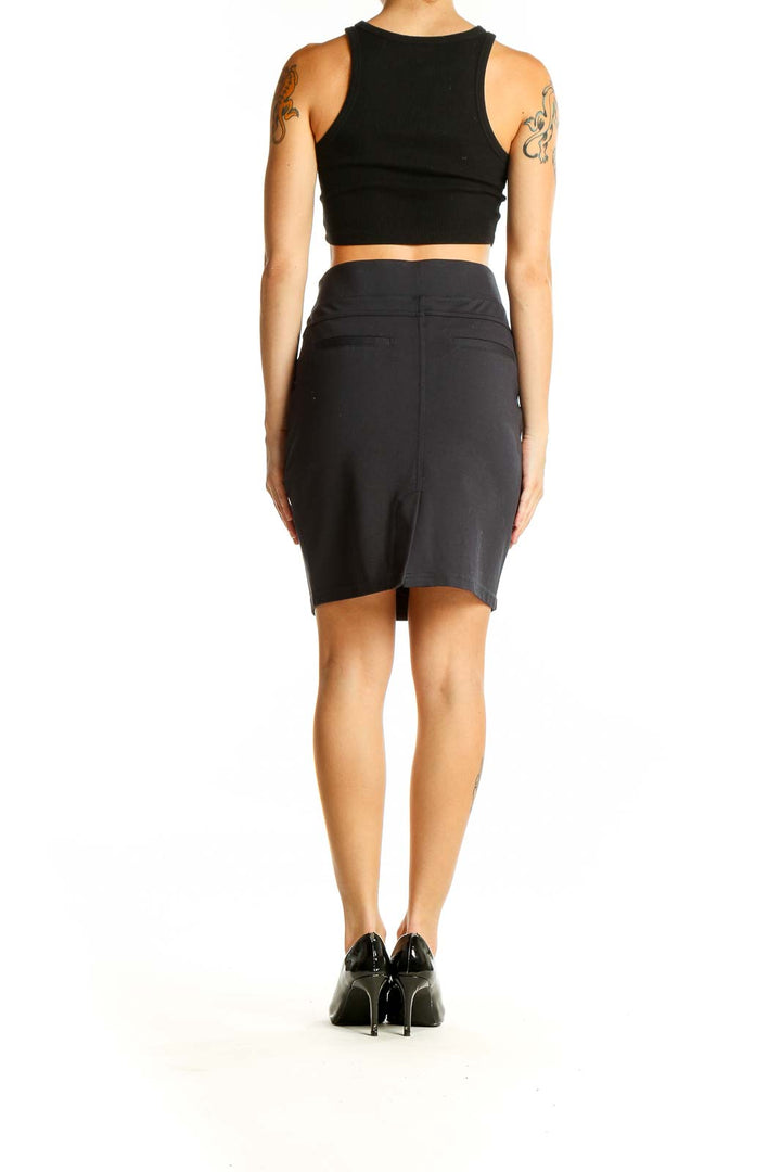 Side view of black pencil skirt paired with black crop top