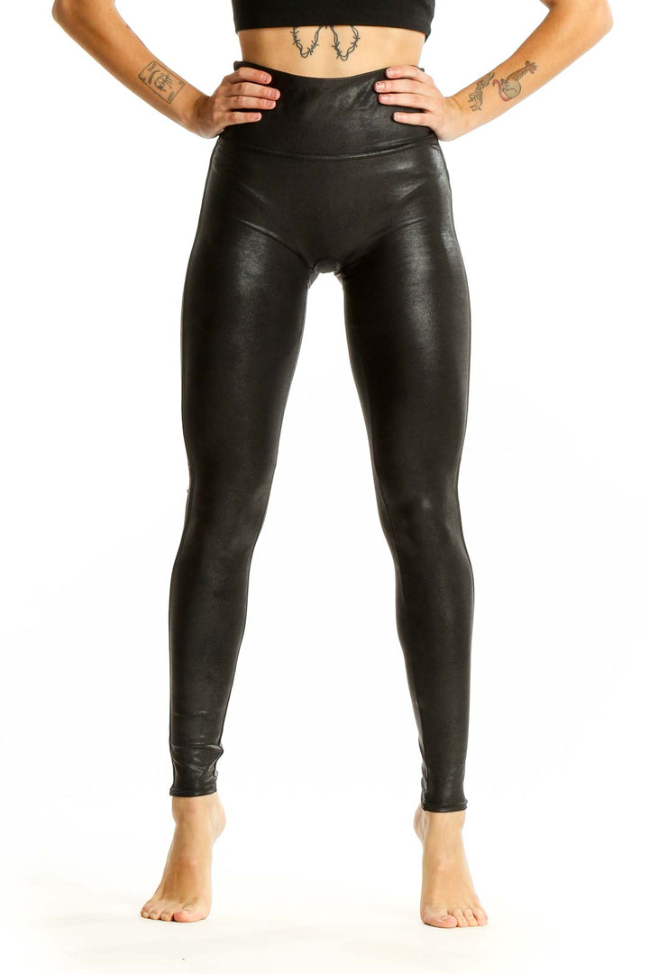 Front view of Spanx black faux leather high-waisted leggings on model