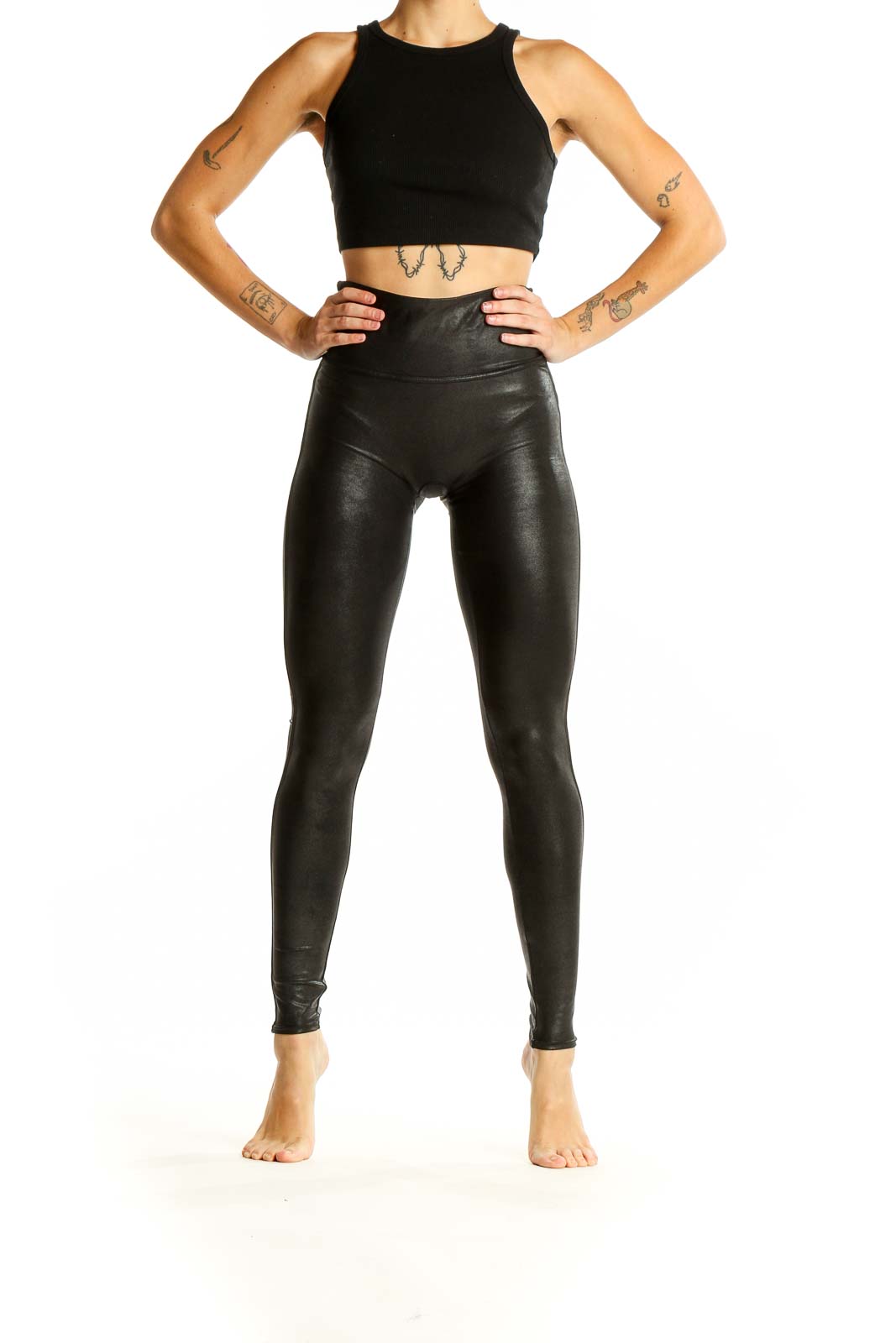 Front view of Spanx black faux leather high-waisted leggings on model