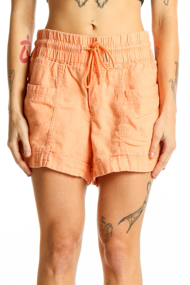 Front view of Athleta peach linen drawstring shorts