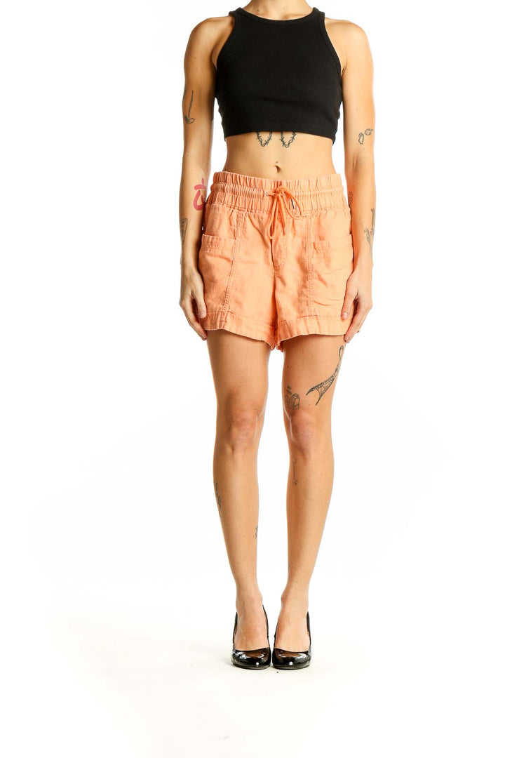 Front view of Athleta peach linen drawstring shorts