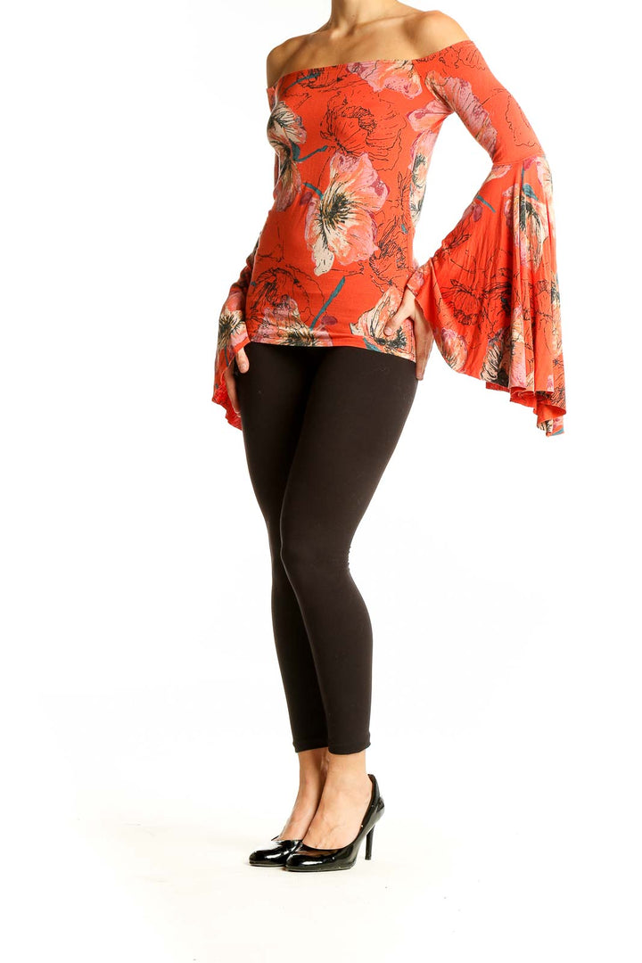 Front view of orange floral off-shoulder top with bell sleeves by WE THE FREE