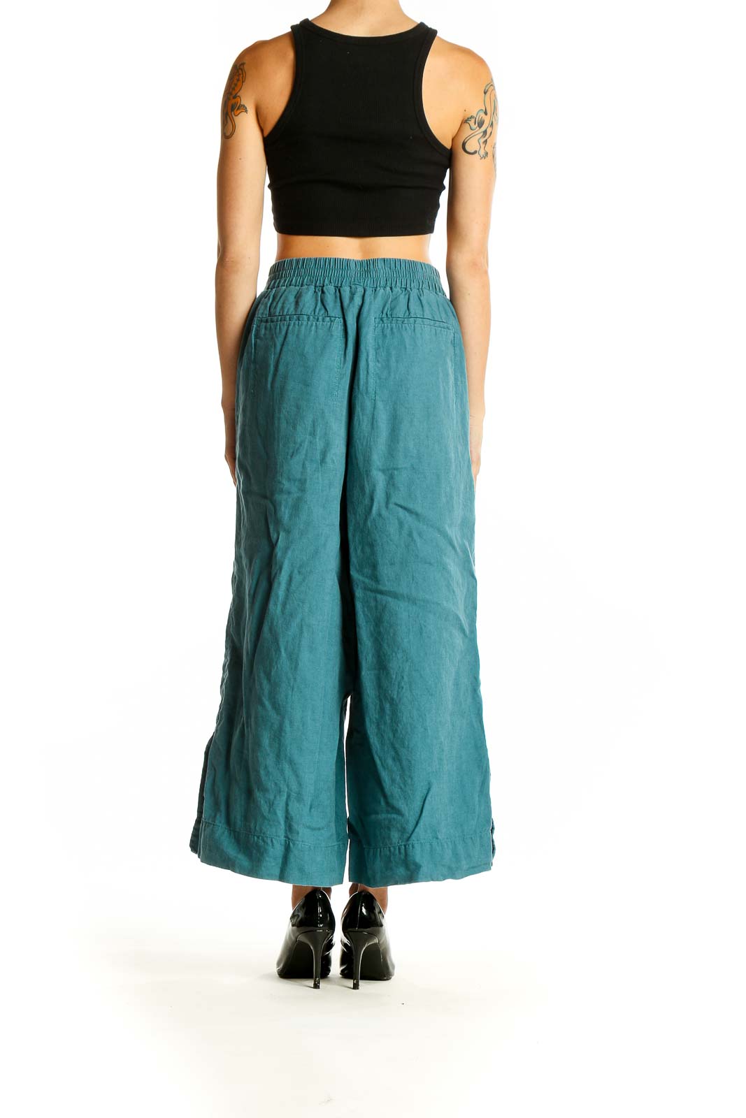 Side view of model wearing teal linen wide-leg cropped pants from Athleta