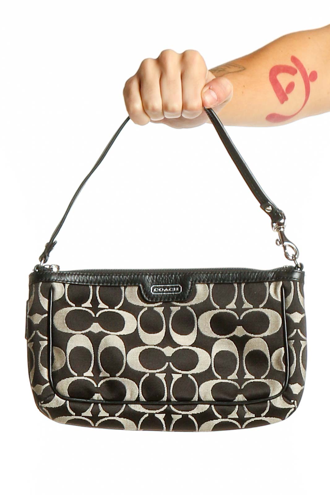 Front view of Coach black and white signature print clutch with zipper closure