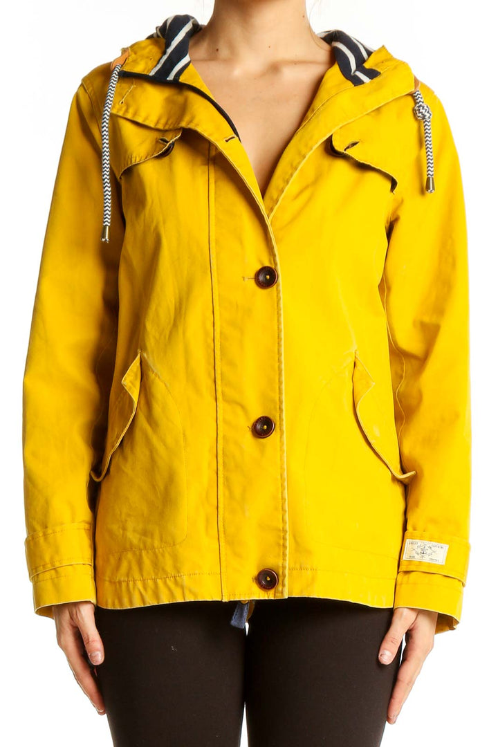 Front view of yellow Joules hooded coat with button closure