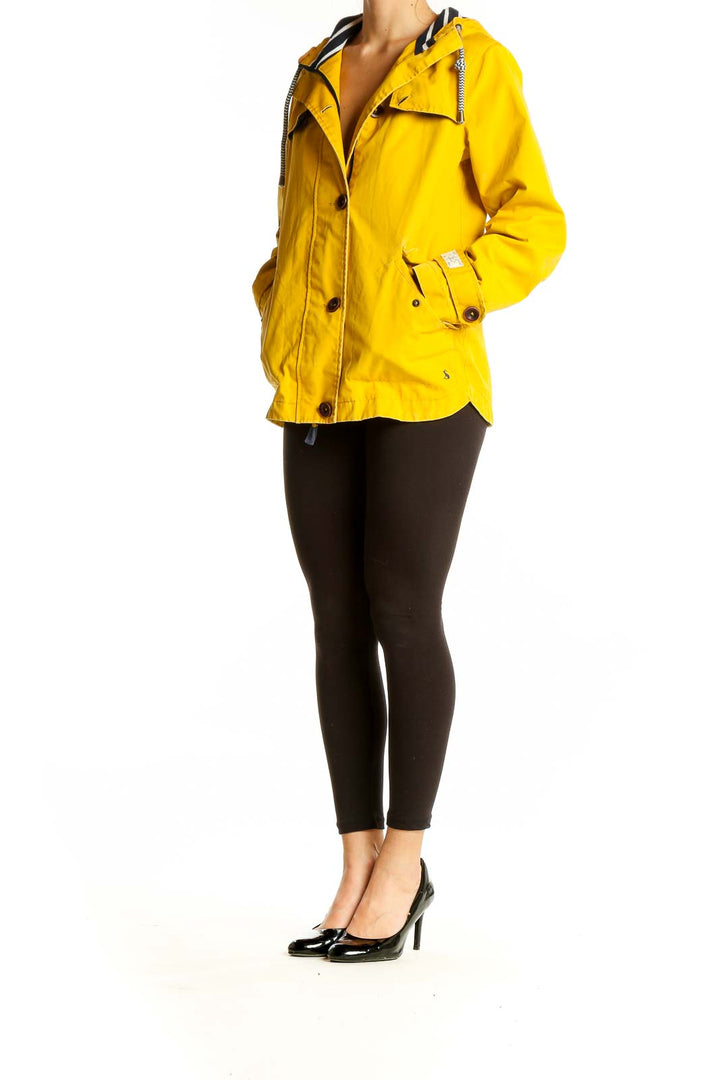 Front view of yellow Joules hooded coat with button closure