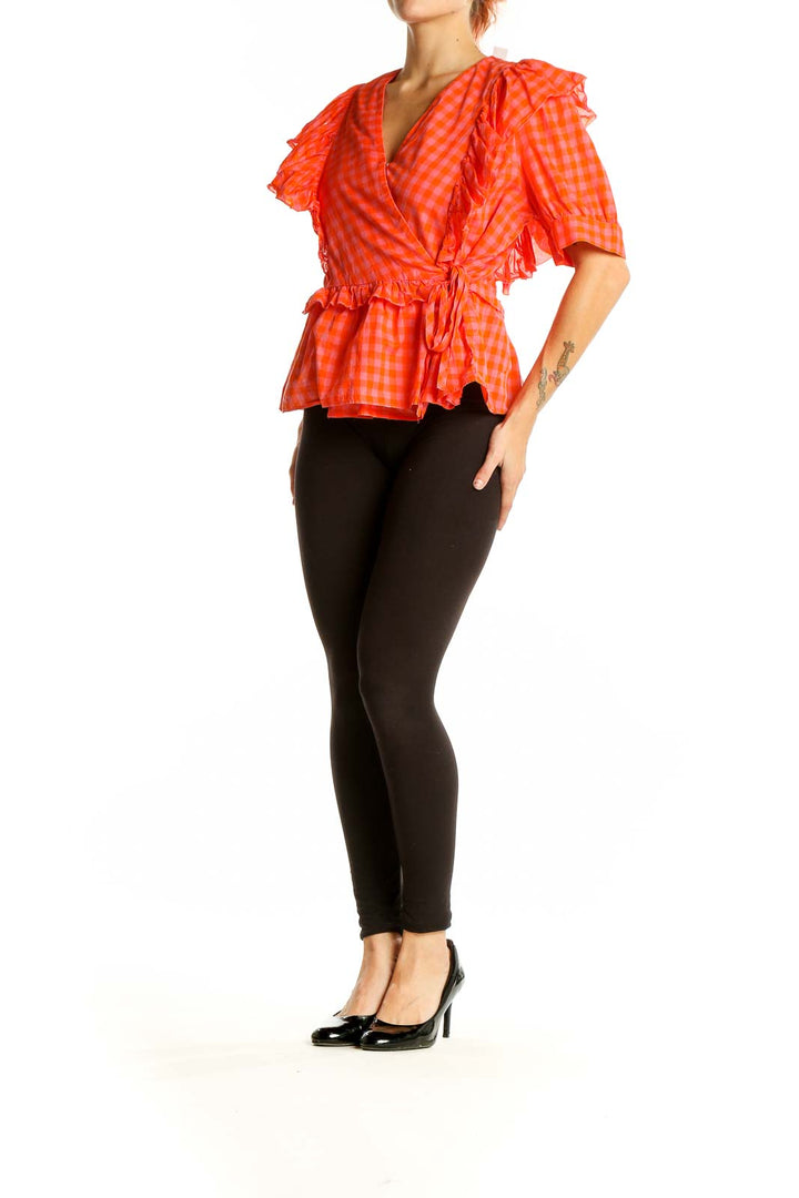 Front view of orange gingham ruffle wrap top from J.Crew
