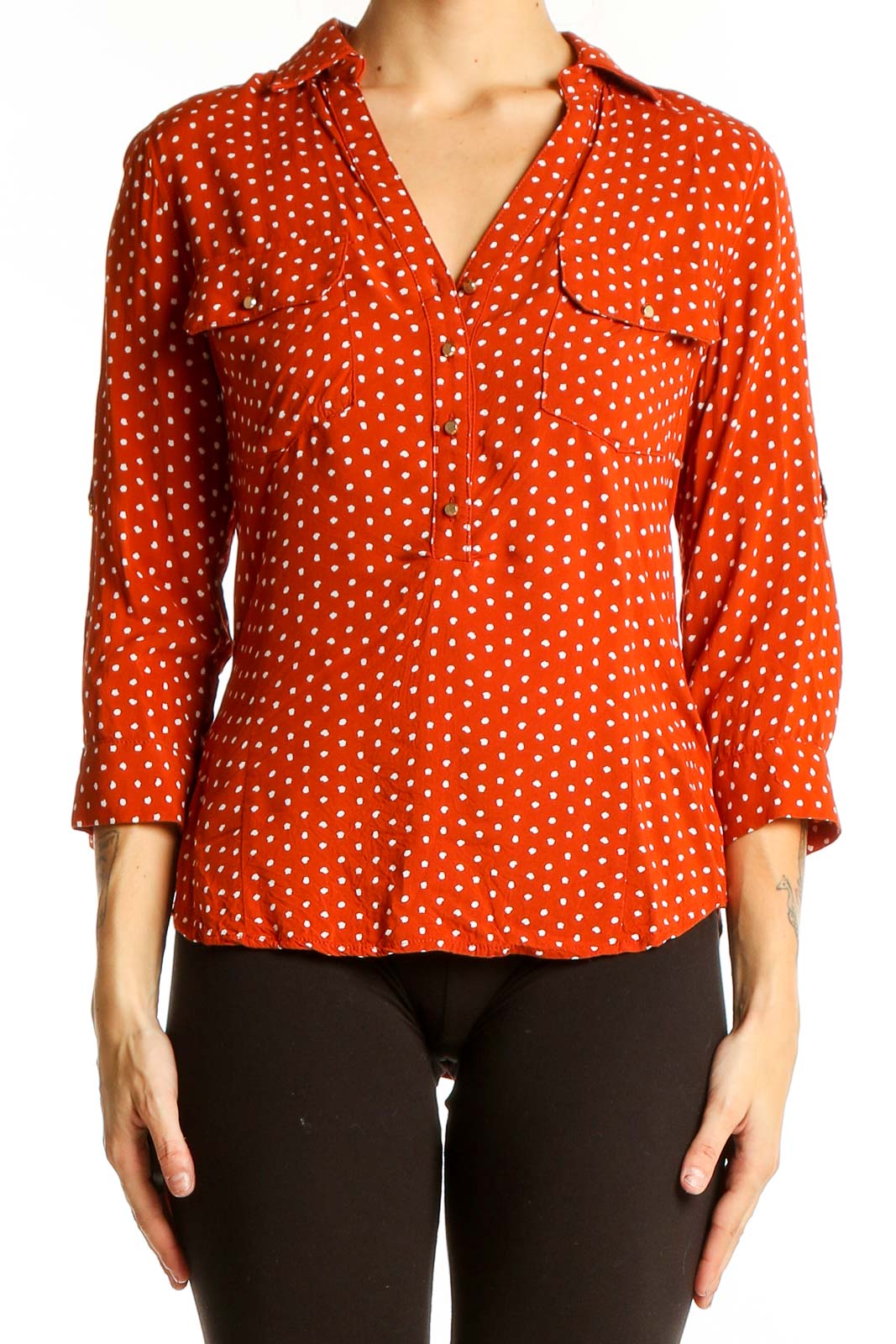 Front view of orange polka dot button-up blouse with 3/4 sleeves