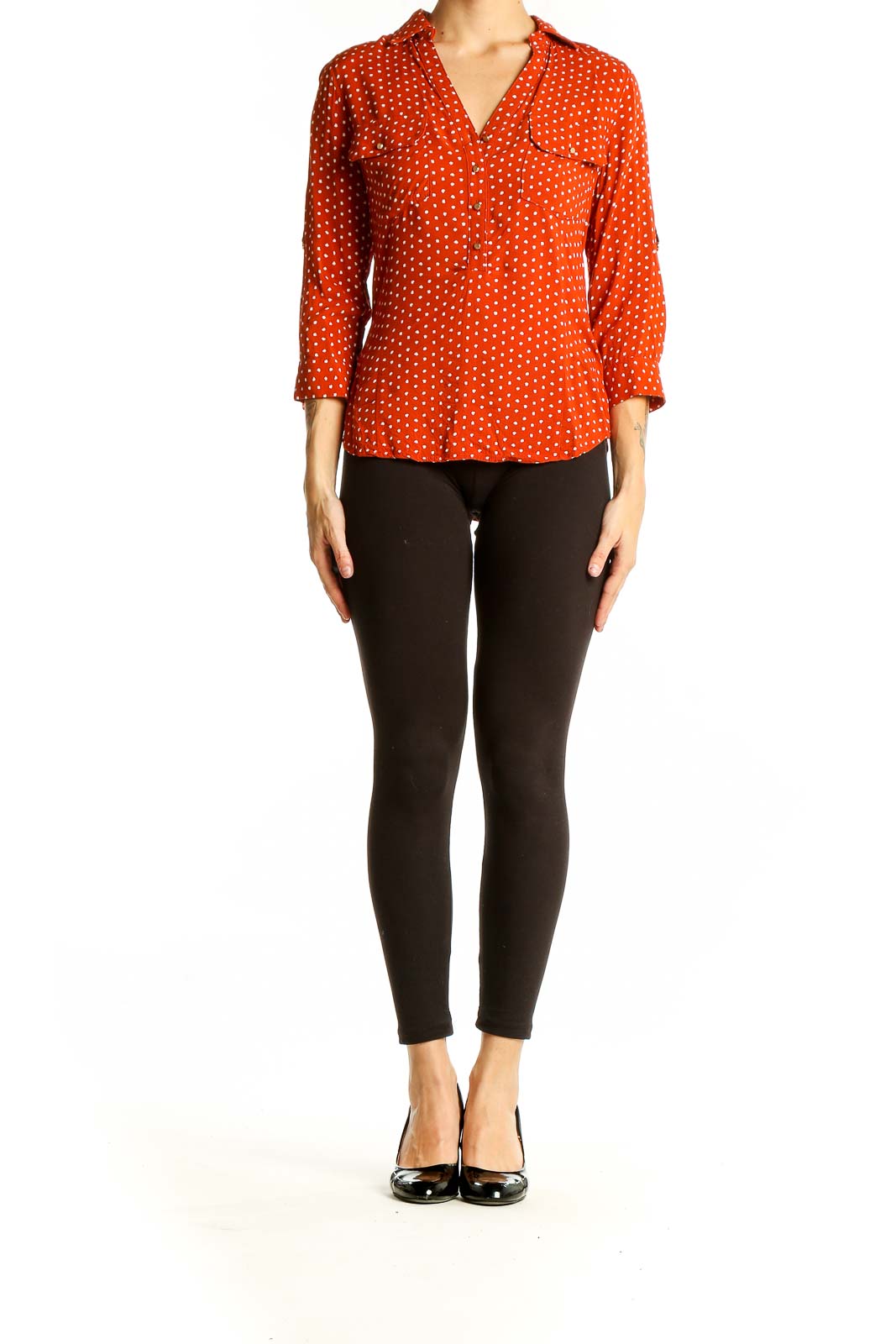 Front view of orange polka dot button-up blouse with 3/4 sleeves