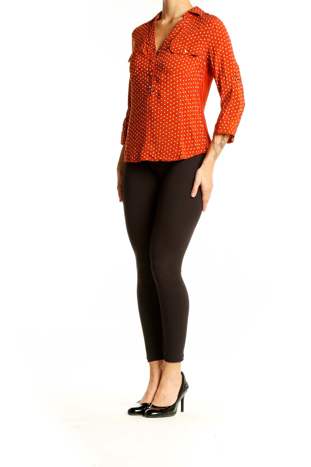 Front view of orange polka dot button-up blouse with 3/4 sleeves