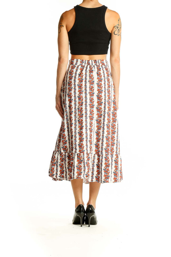 Side view of model wearing o.p.t. White Floral Striped Cotton Midi Skirt with black top