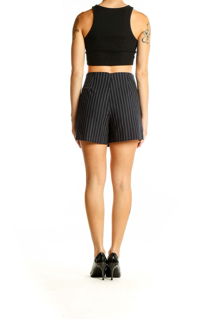 Side view of SilkRoll black pinstripe wrap mini skirt with crop top