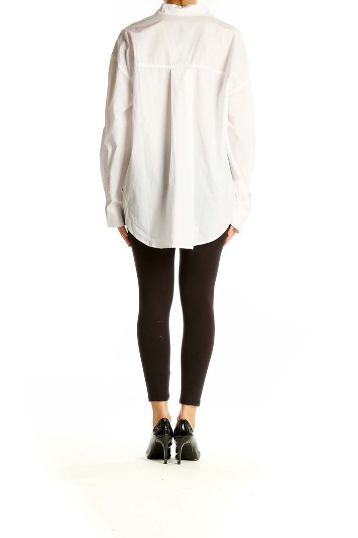 Back view of English Factory white eyelet lace button-down shirt on model with black pants