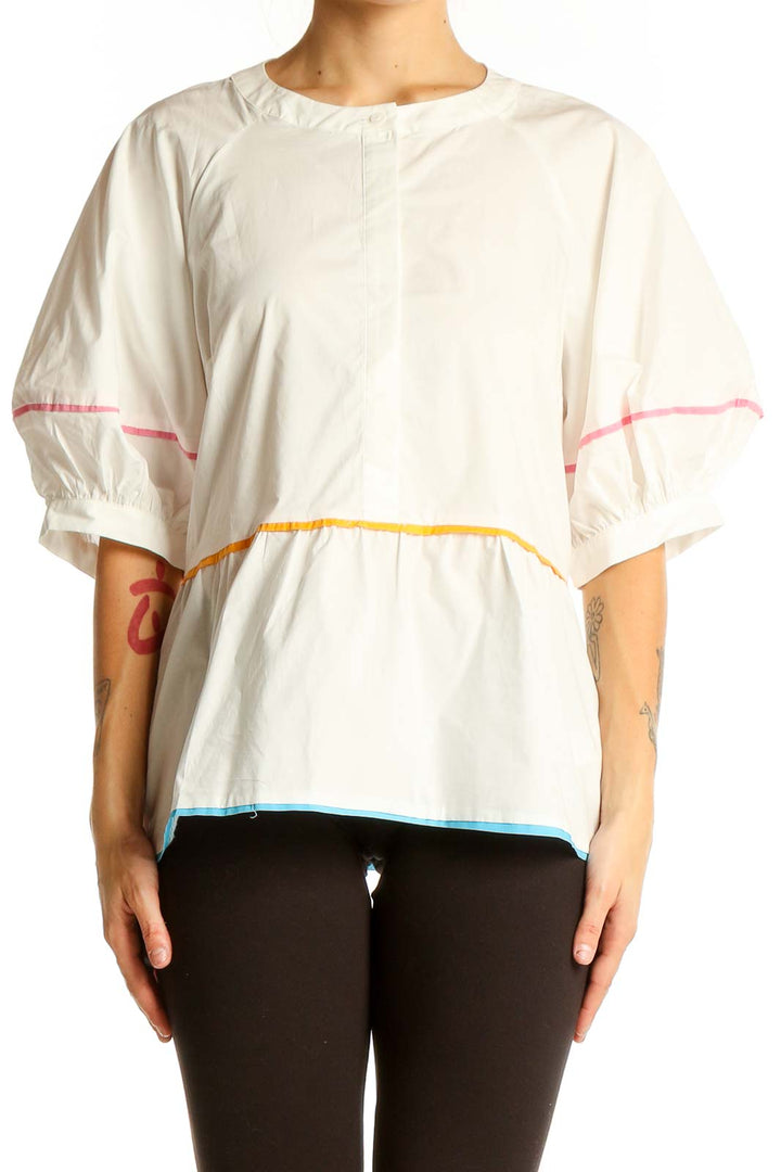 Front view of English Factory white cotton peplum top with colorful trim and voluminous sleeves