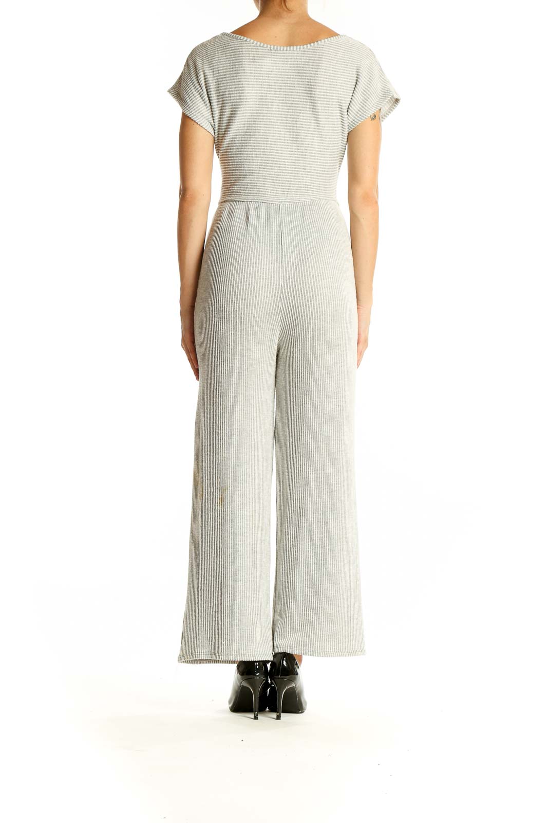 Side view of gray ribbed tie-front jumpsuit showing wide-leg silhouette