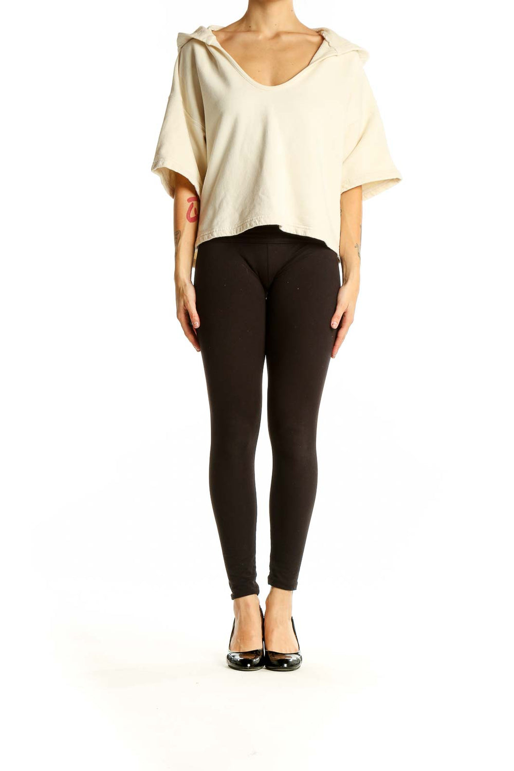 Front view of Joie cream cropped hooded knit top on model