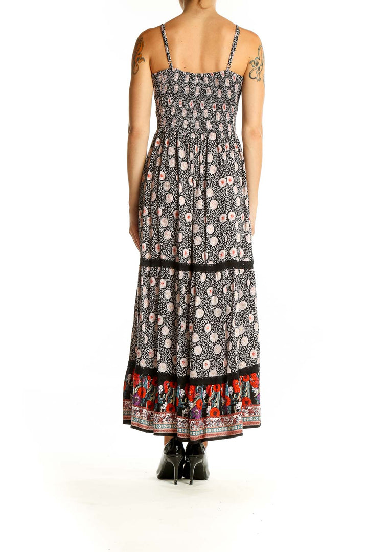 Side view of SilkRoll black floral print maxi dress showing empire waist and tiered skirt