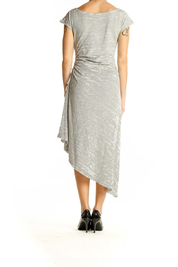 Side view of Max Studio gray striped asymmetrical midi dress showing flowing hemline