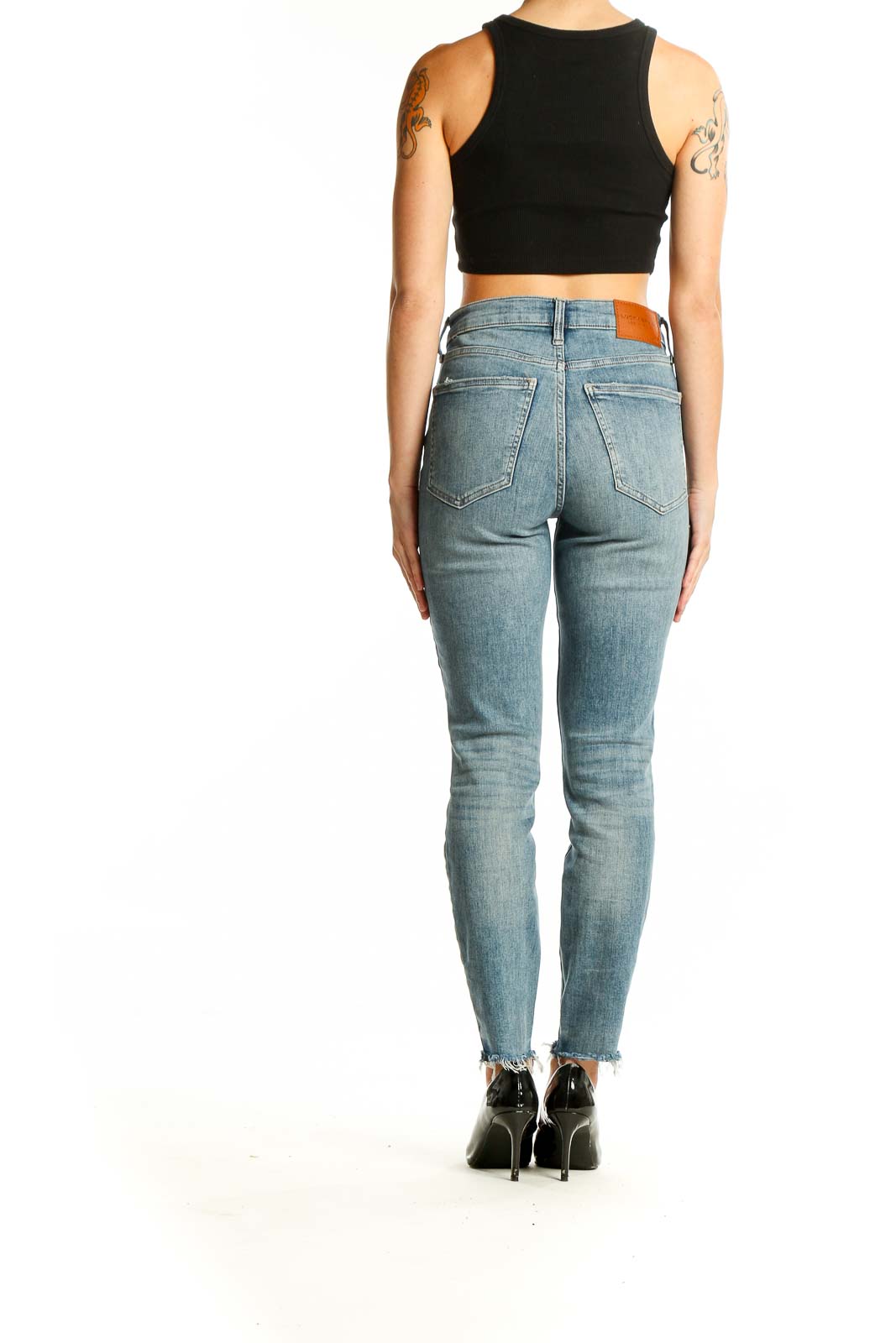 Back view of Lucky Brand light blue distressed skinny jeans on model