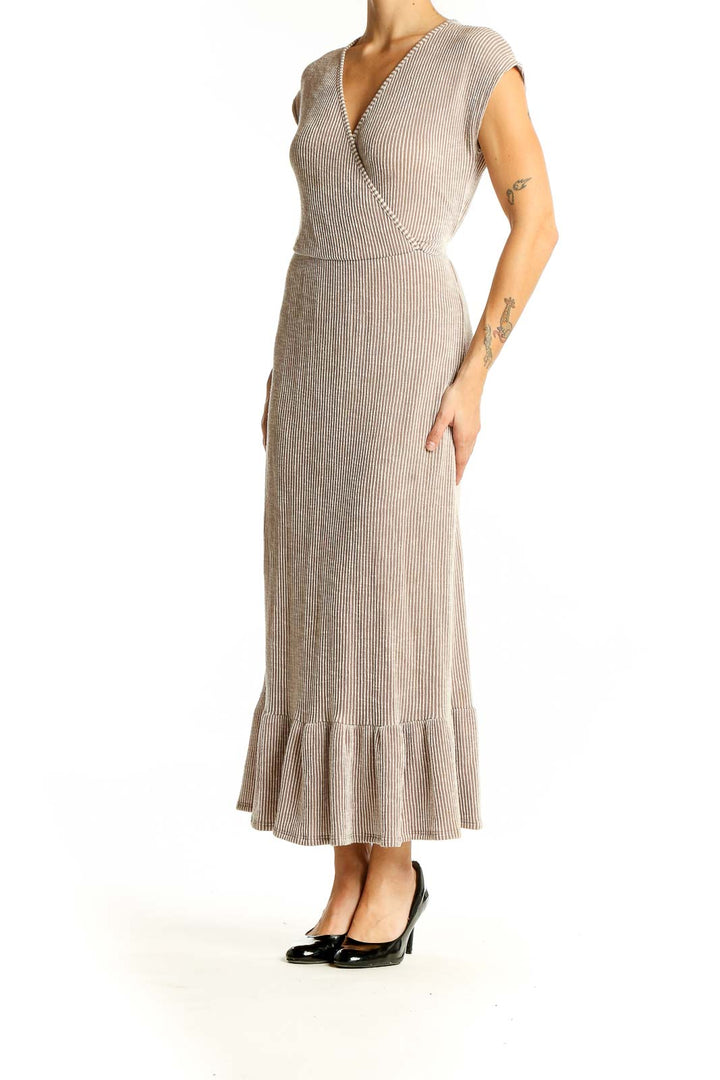 Front view of beige ribbed wrap maxi dress with V-neck and ruffle hem