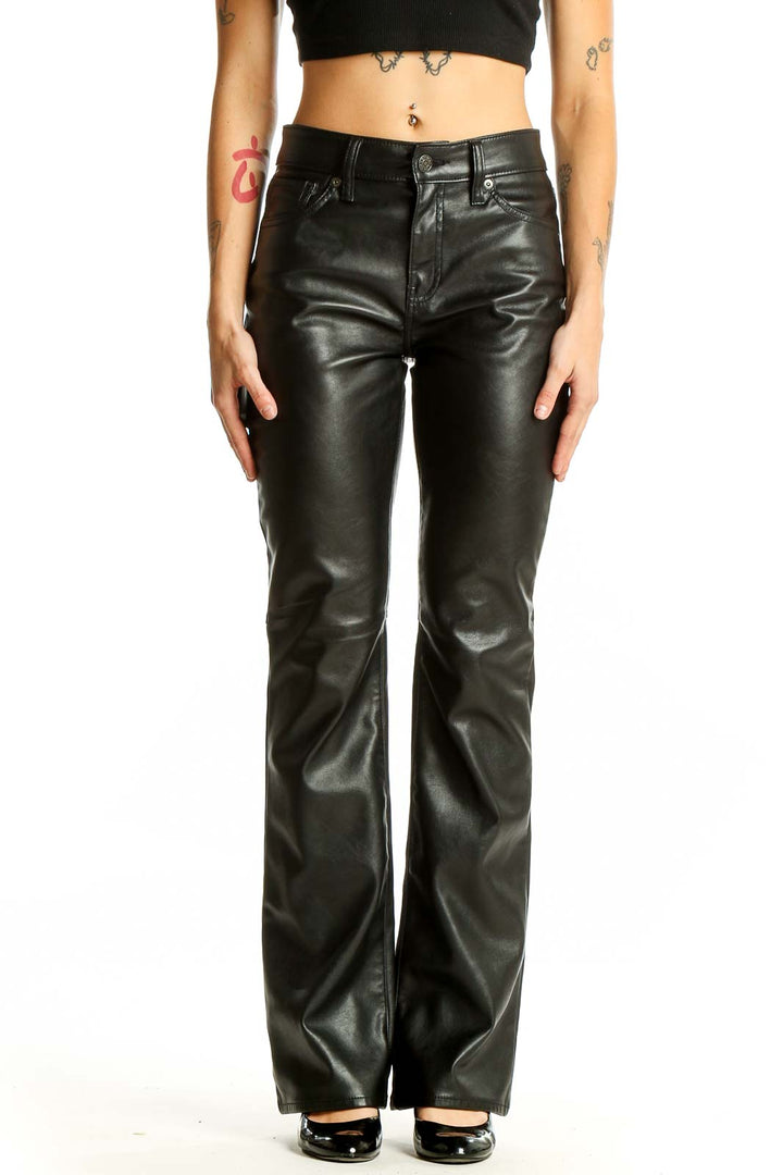 Front view of Gap black faux leather flare pants on model