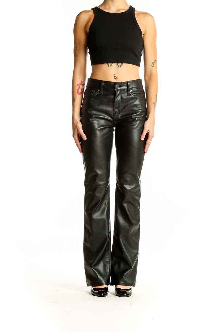 Front view of Gap black faux leather flare pants on model