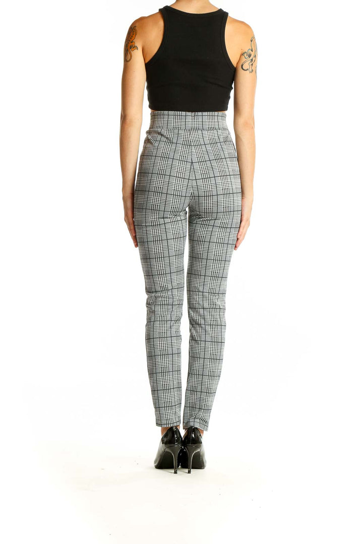 Side view of model wearing SilkRoll gray plaid high-waisted slim pants with black top