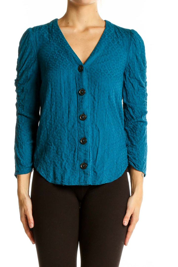 Front view of teal textured Maeve blouse with V-neck and button-down design