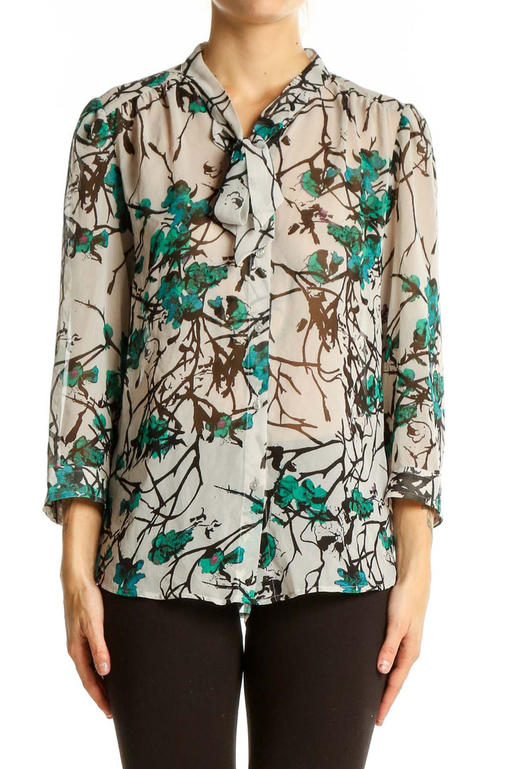 Front view of LOFT beige blouse with teal floral print and button-up design