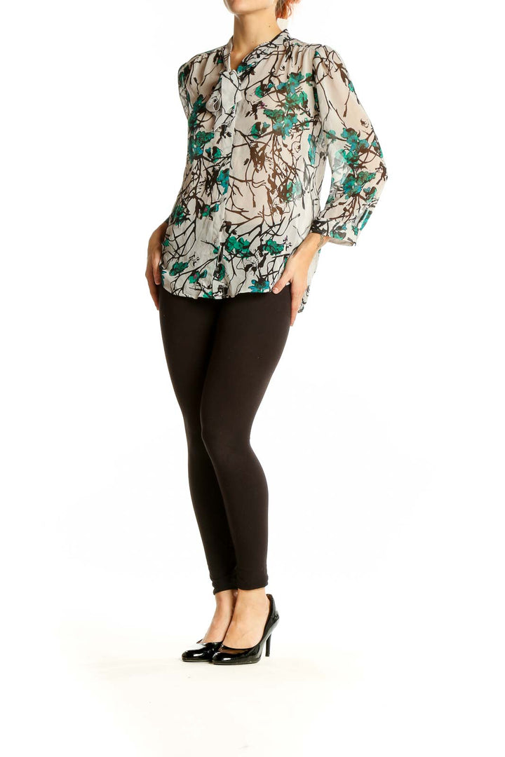 Front view of LOFT beige blouse with teal floral print and button-up design