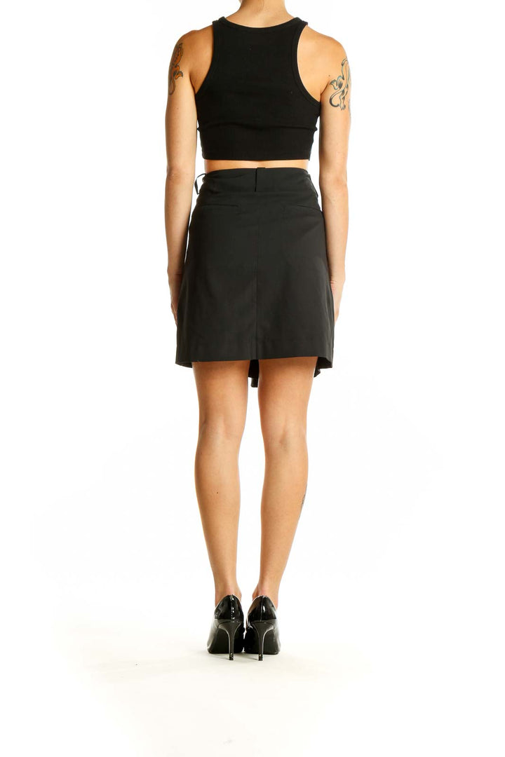 Side view of black high-waisted Nike Golf skort on model