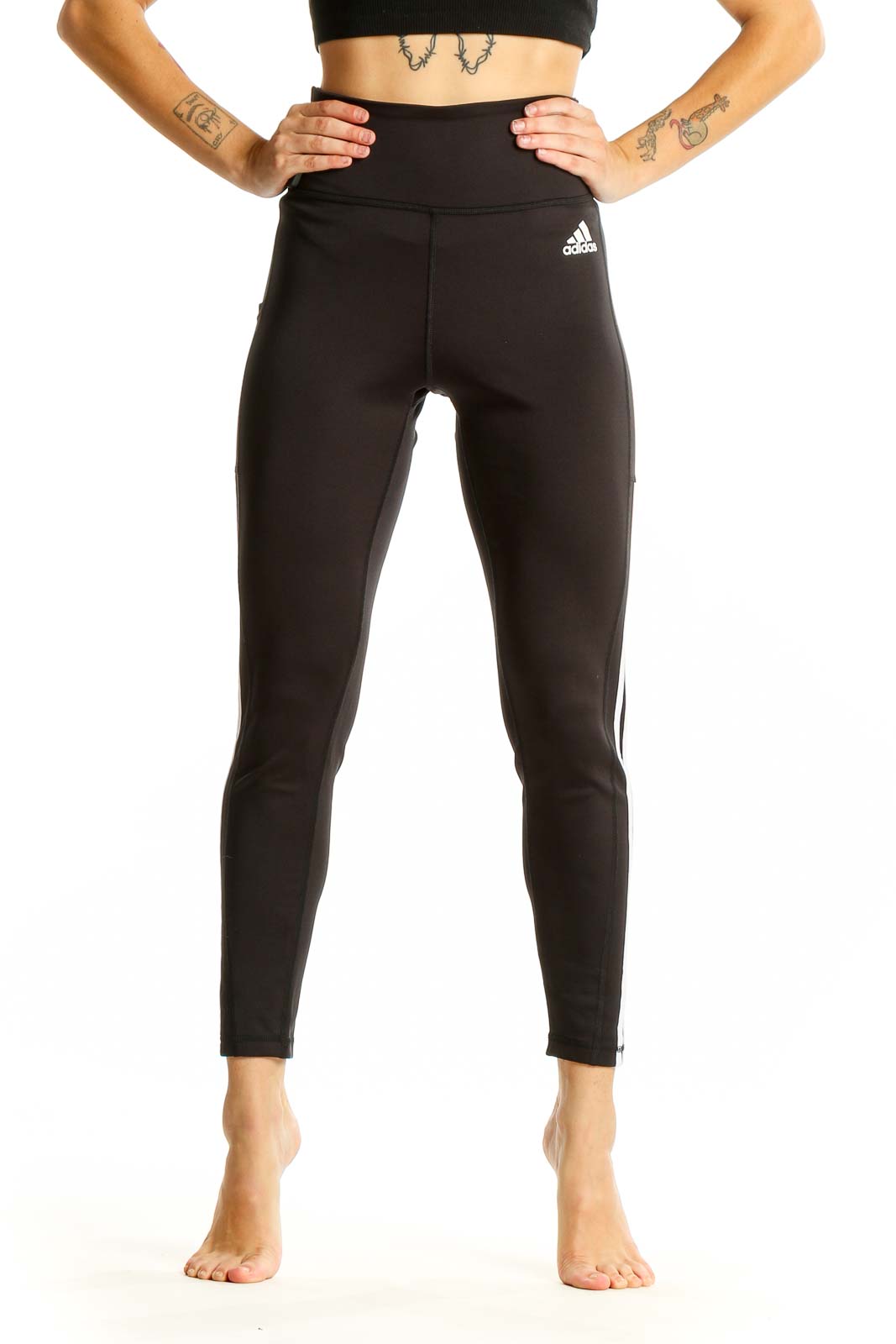 Front view of black Adidas high-waisted leggings with three-stripe design