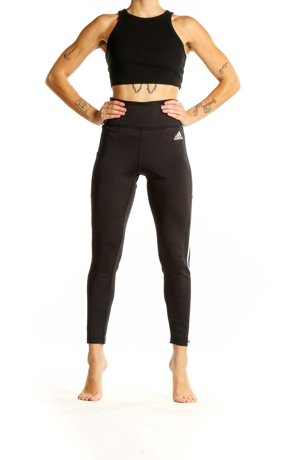 Front view of black Adidas high-waisted leggings with three-stripe design