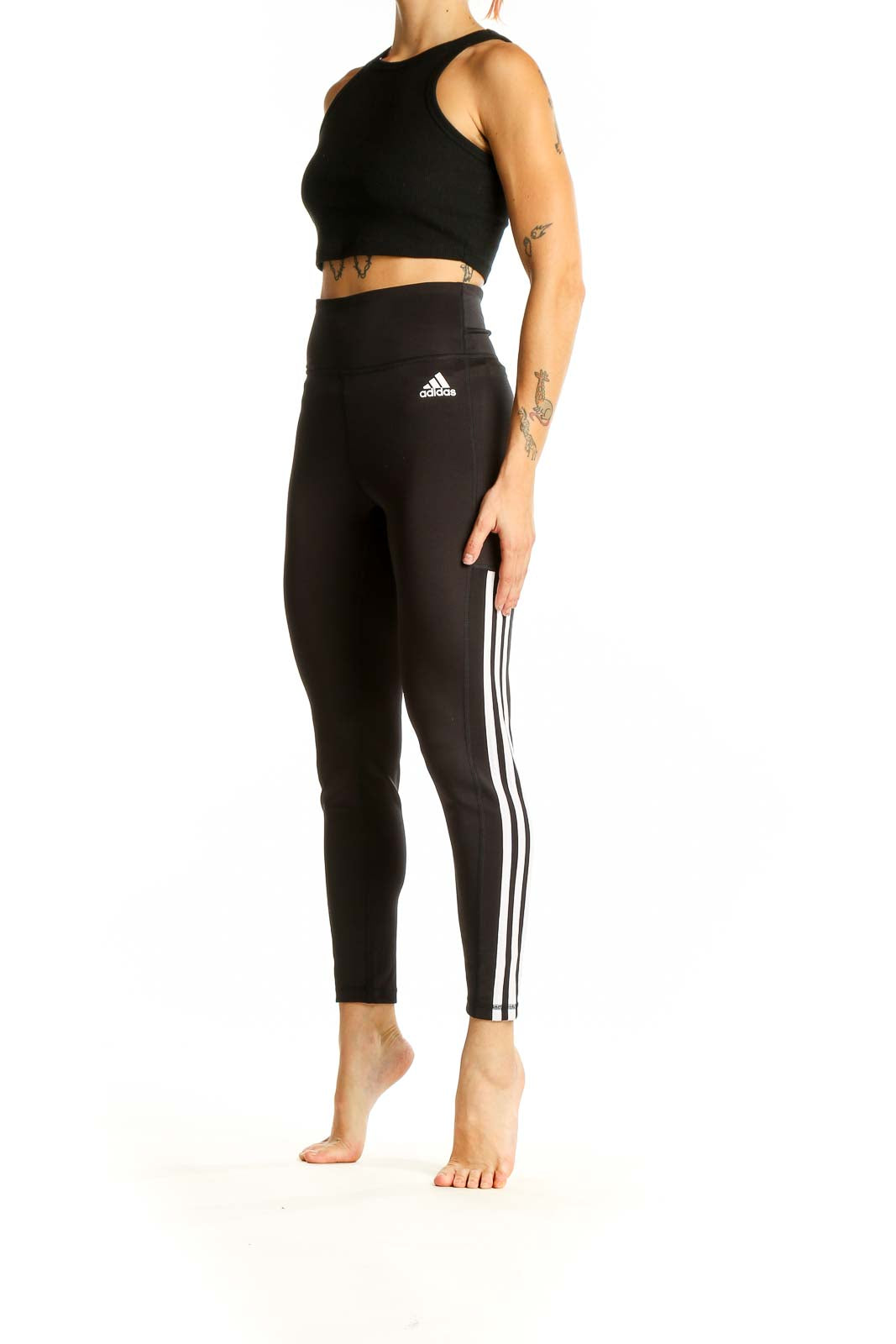 Front view of black Adidas high-waisted leggings with three-stripe design