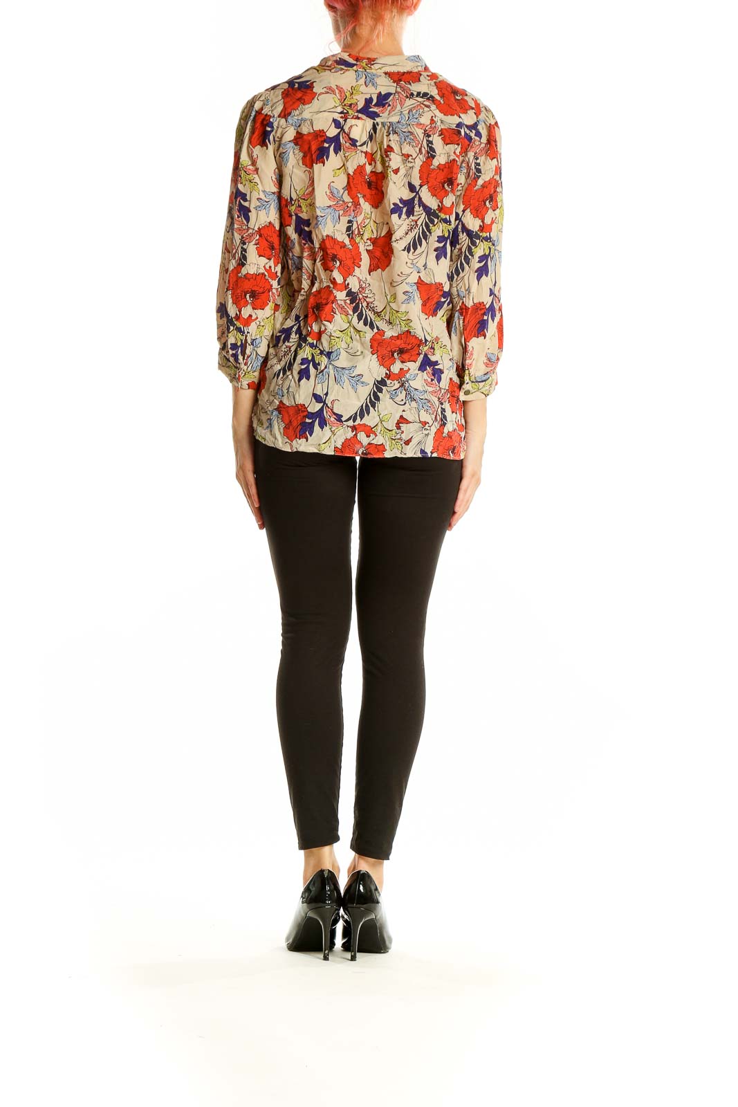 Side view of model wearing Banana Republic beige floral silk blouse with black pants