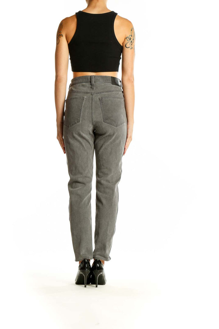 Back view of Madewell gray high-waisted straight leg jeans on model