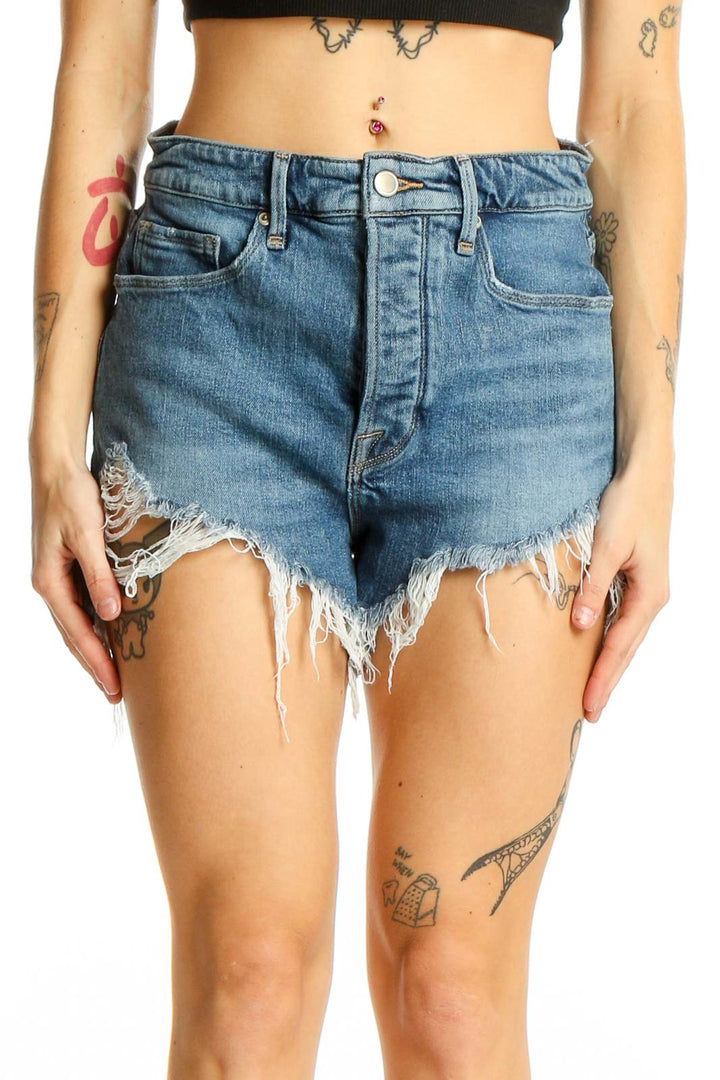 Front view of Good American blue denim cutoff shorts with distressed details