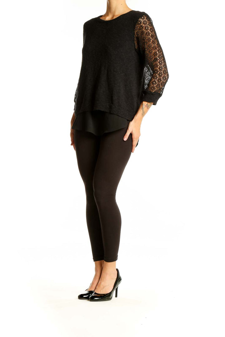 Front view of Lucky Brand black sweater with lace sleeves and layered hem