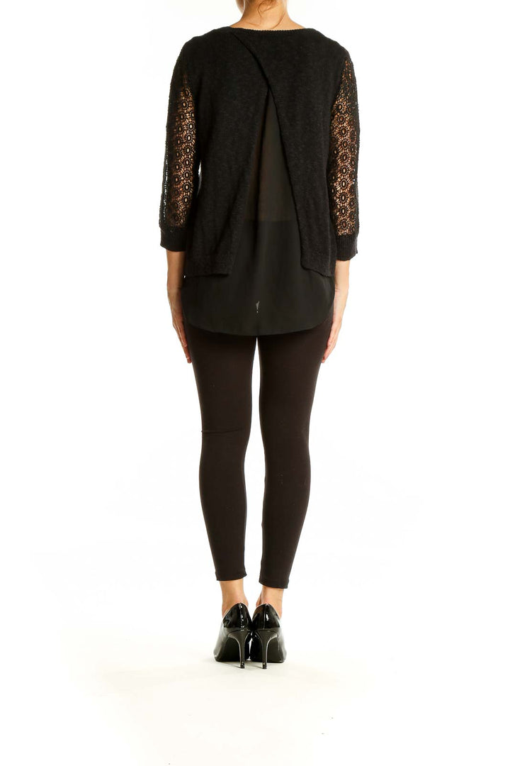 Back view of Lucky Brand black sweater showing split detail and lace sleeves