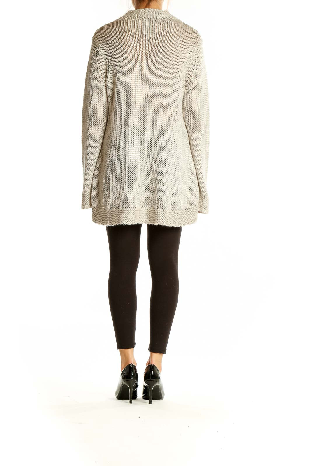 Side view of Stella Carakasi beige oversized chunky knit sweater showing bell sleeves and length