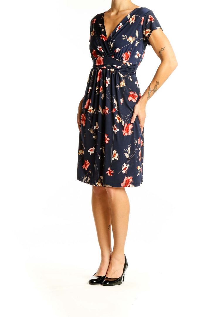 Front view of Kaileigh navy floral wrap midi dress with V-neckline and short sleeves