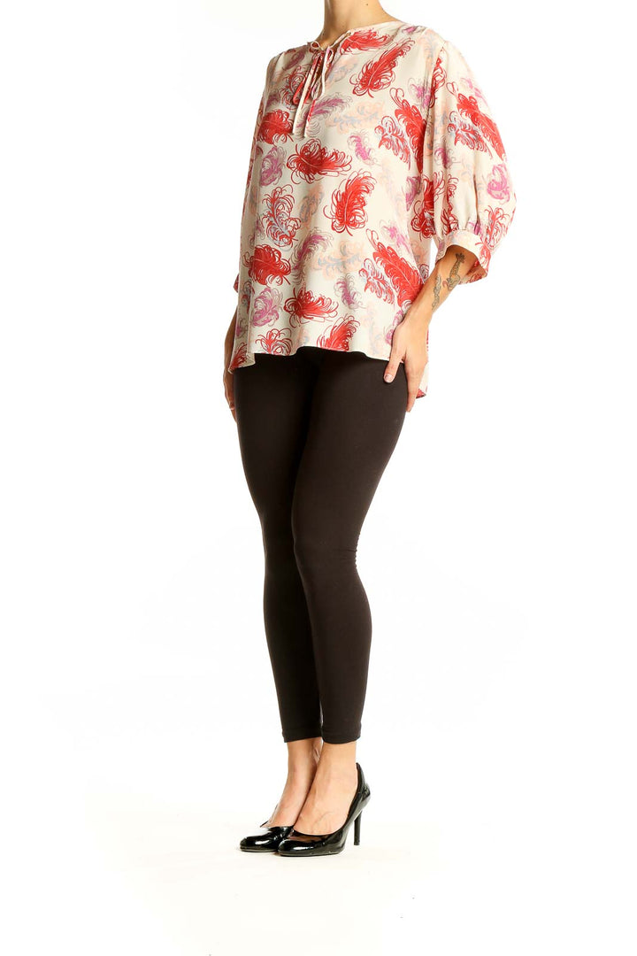 Front view of Tucker red feather print silk blouse with tie neckline