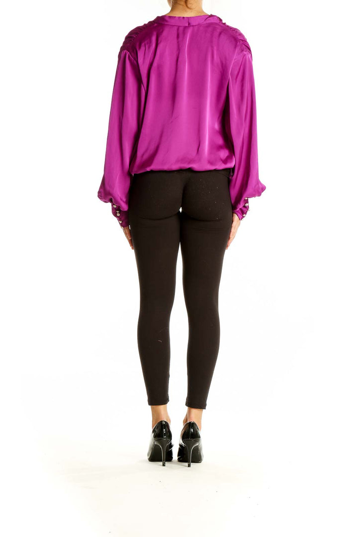 Back view of magenta wrap-style polyester blouse from Express with black pants