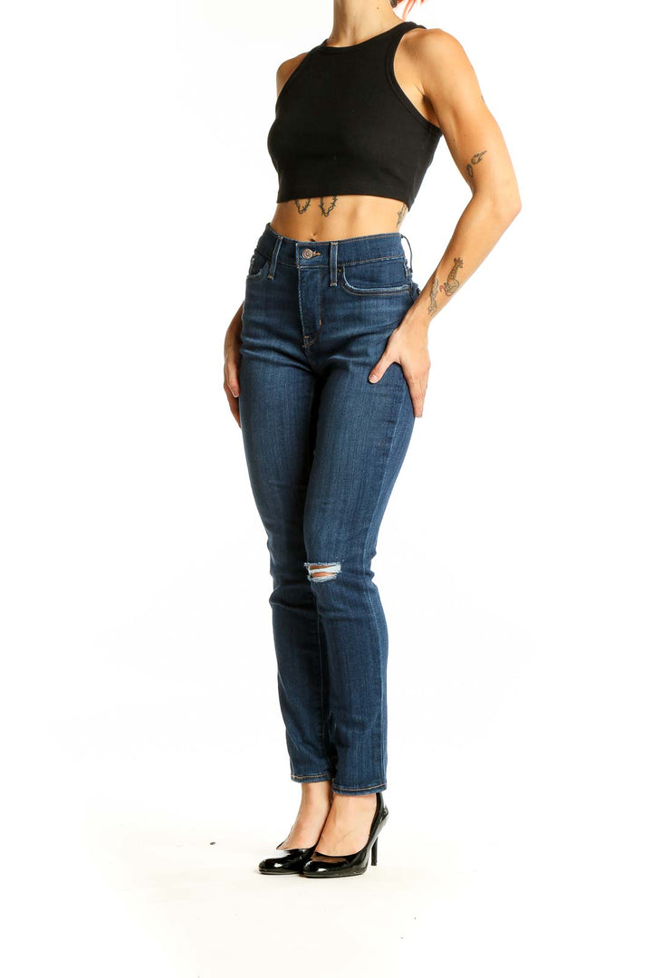 Front view of Levi's blue distressed skinny jeans on model